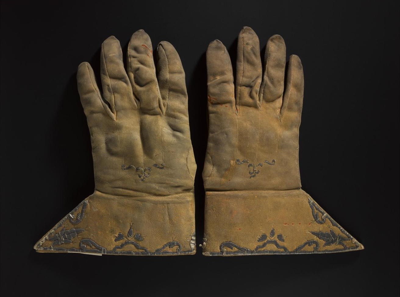 Pair of gloves said to have been worn by John Graham of Claverhouse, Viscount Dundee. Leather, silver wire, 17th century.