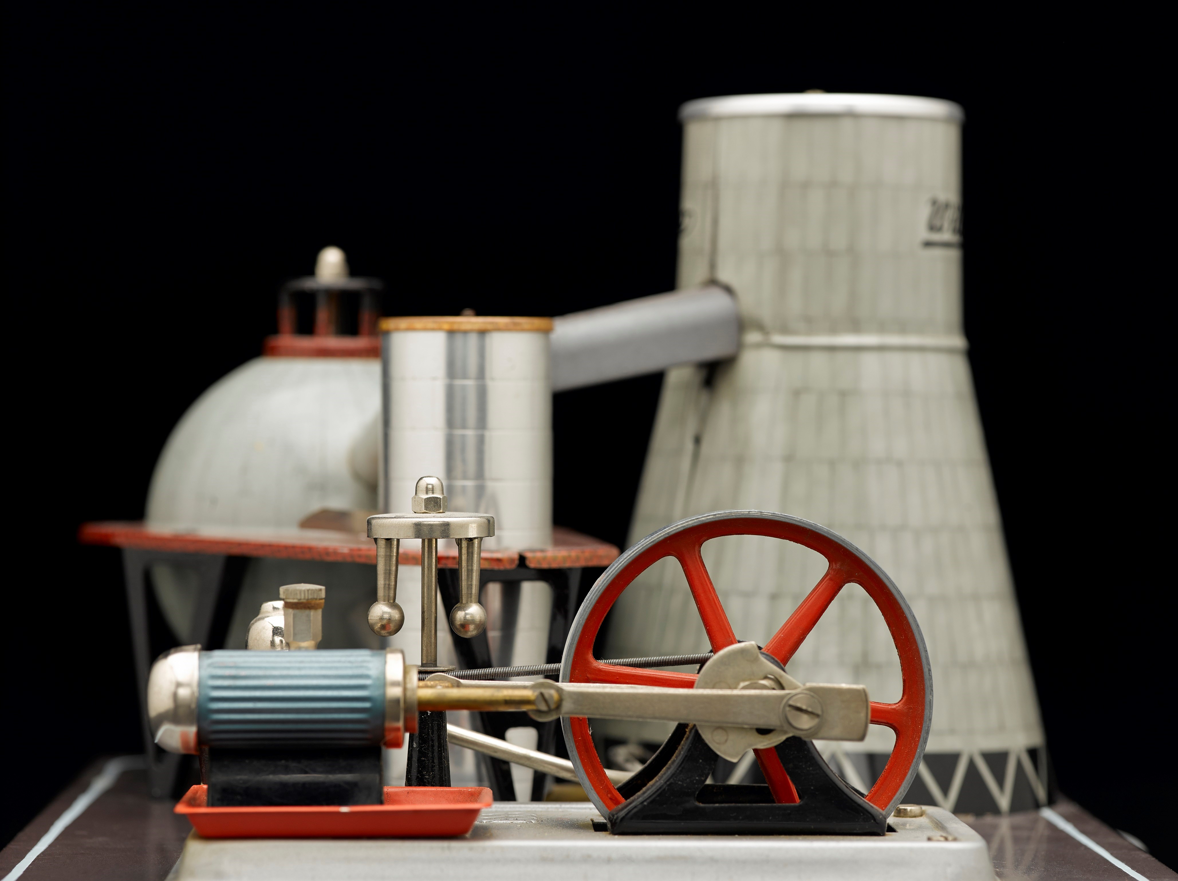 Model of a minature power station in red and metalics.