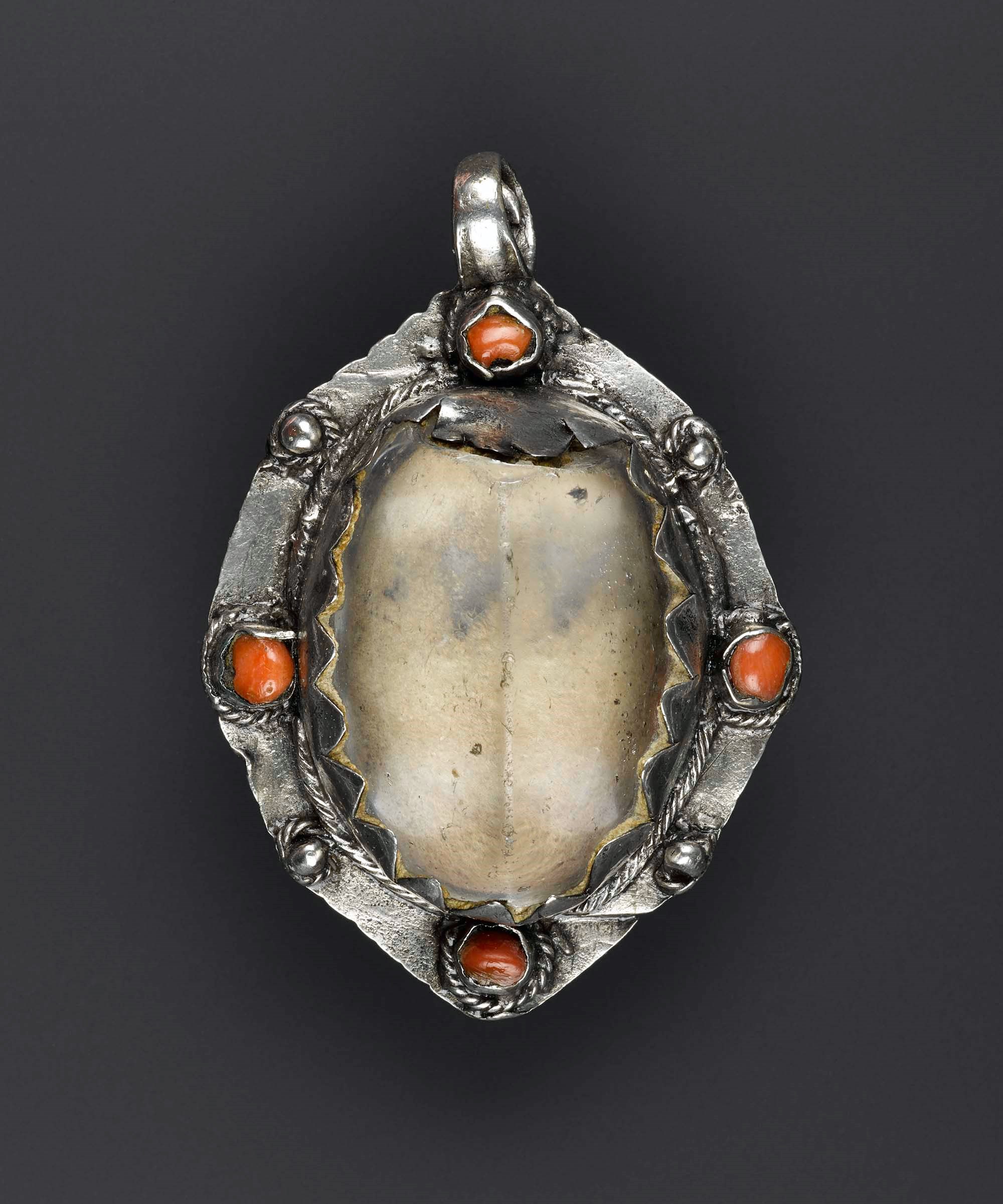 An oval shaped pendant with a crystal centre and jewels on the outer edge.