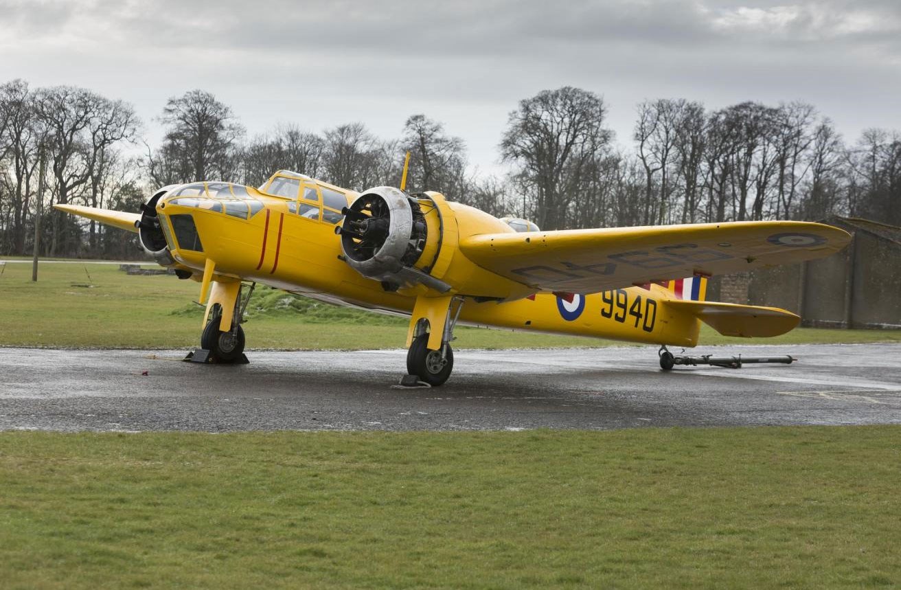 A yellow Bristol Bolingbroke aircraft parked on a runway.