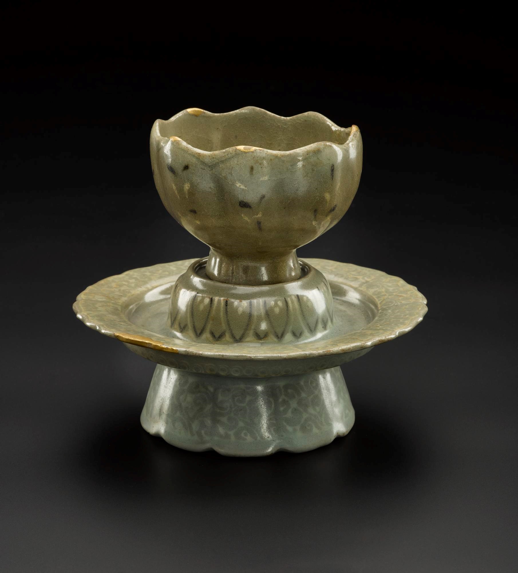 Lotus-shaped cup and stand of stoneware, decorated with inlaid designs in white and brown slip under a blue-green glaze: Korea, Goryeo Dynasty, 918 - 1392 AD.