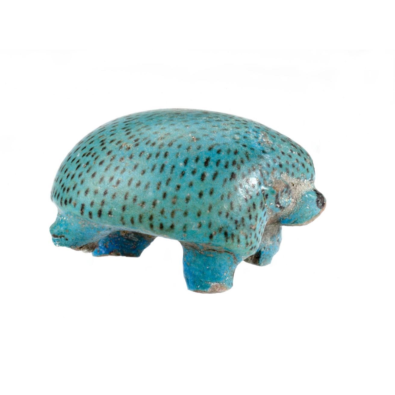  Figurine of a hedghog in a marching pose, made of blue faience with the quills indicated by brown flecks: Ancient Egyptian, Middle Kingdom.