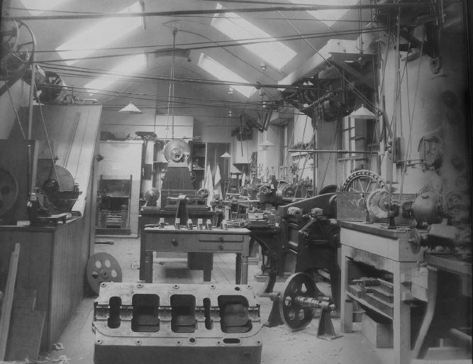 The roof top workshop c.1926. Models in the picture include a model water filter and the hull of a ship.