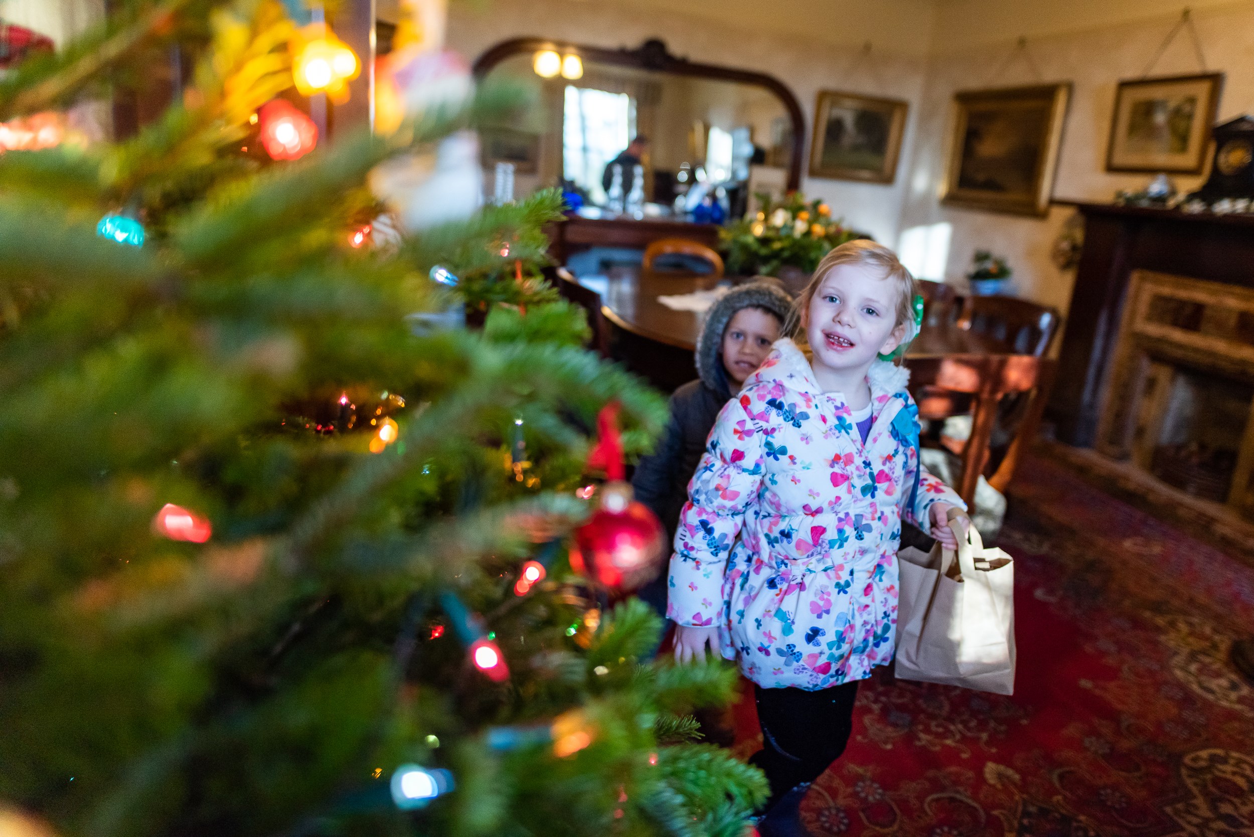 Two children looking at a Christmas tree in the museum