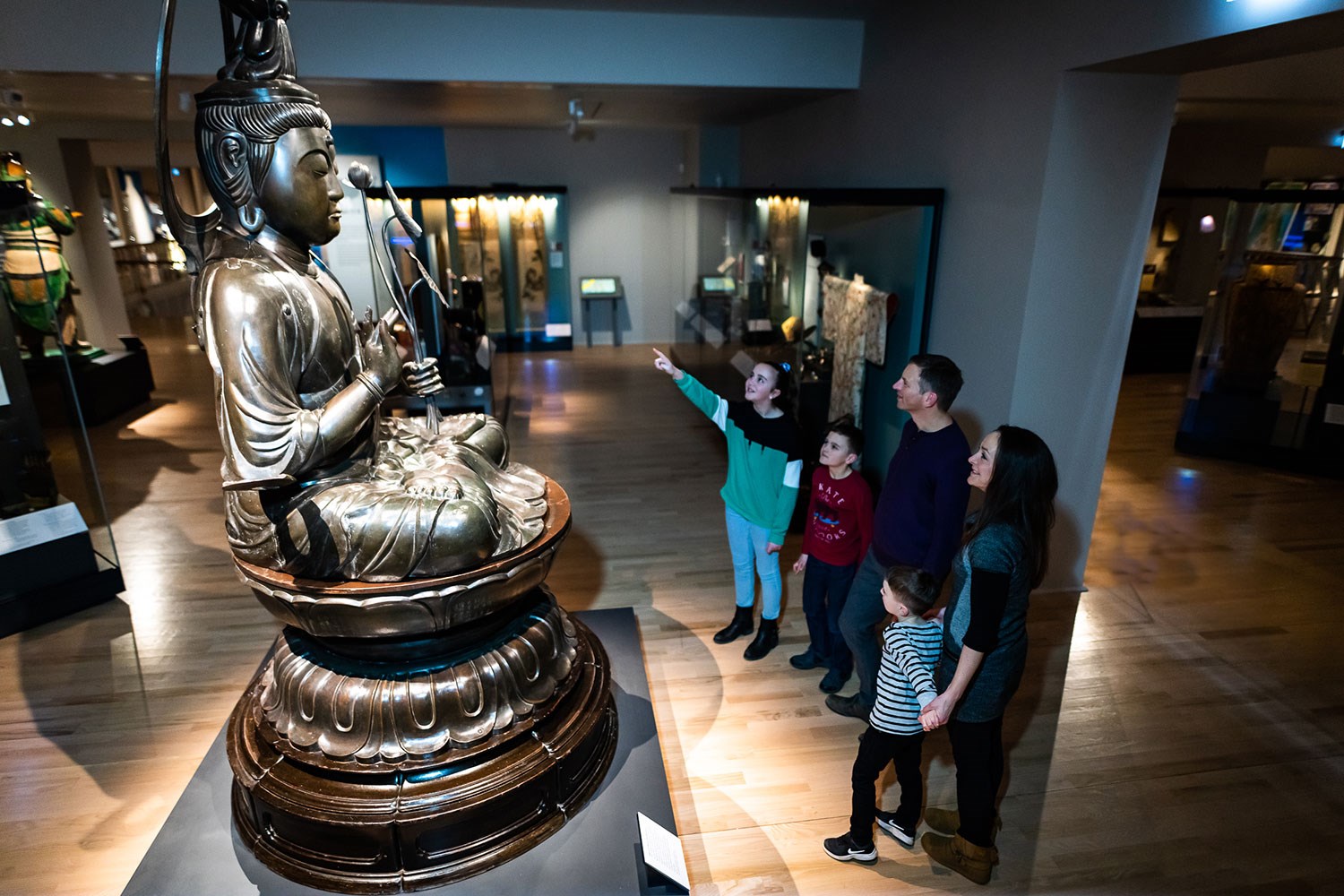 A group of visitors in the Exploring East Asia gallery on Level 5.