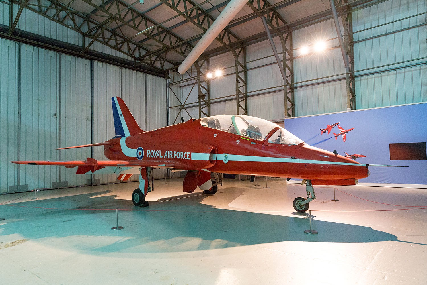 Red Arrows Hawk aircraft inside a large hangar