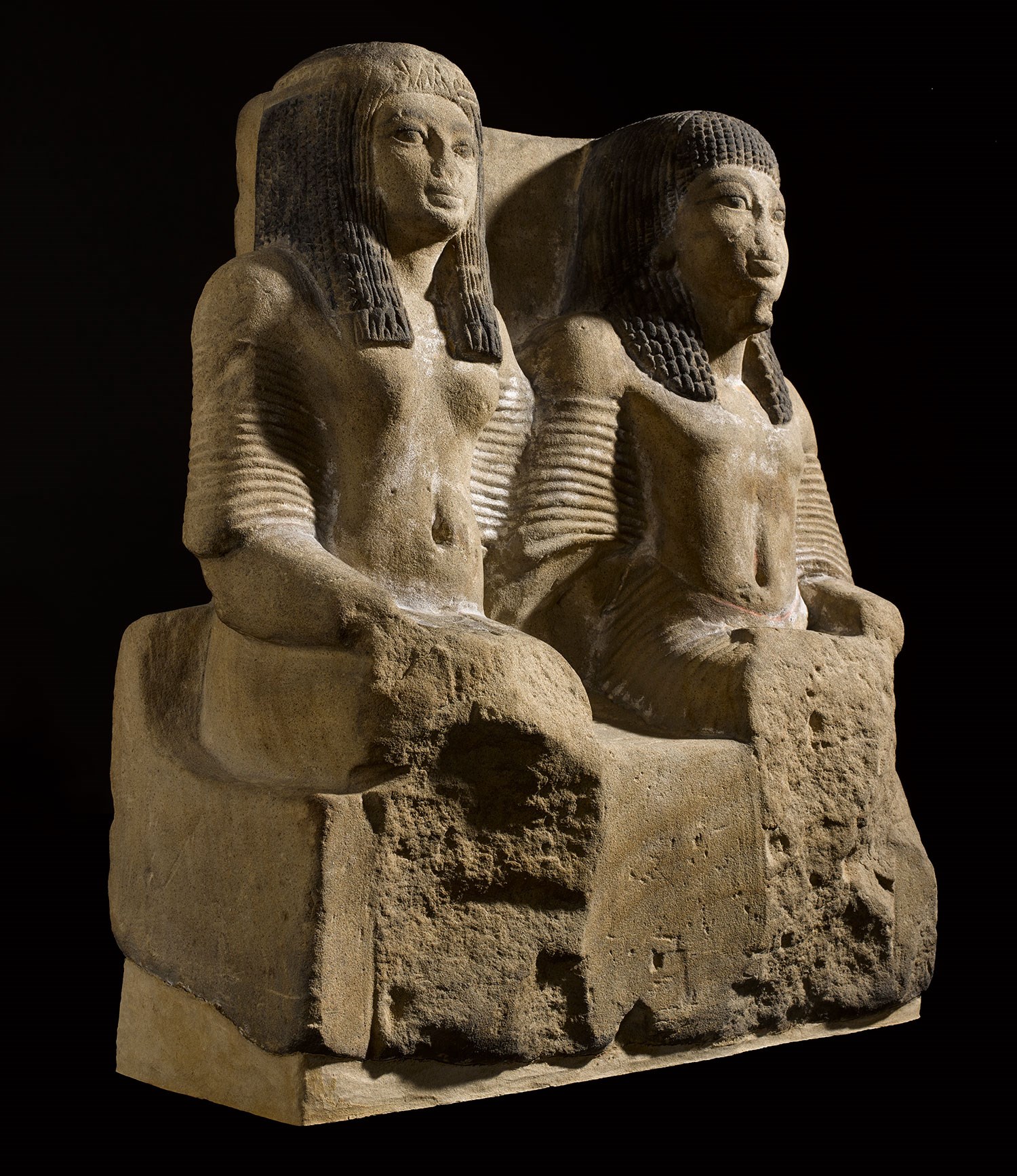 Pair statue in fine yellow sandstone of a Chief of Police (Medjay) and his wife, Sheikh Abd el-Qurna, Thebes, c.1322-1279 BC.