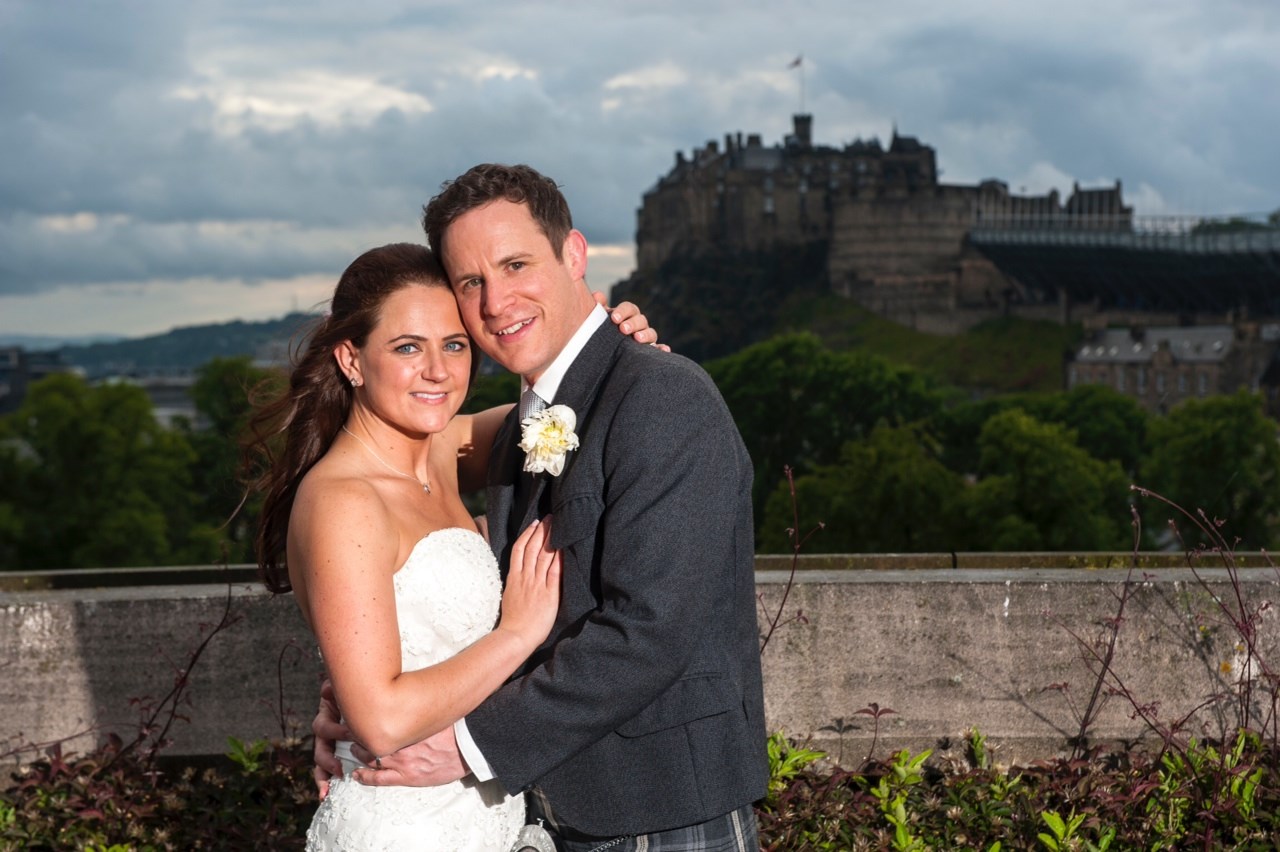 Newlyweds on the National Museum of Scotland's Roof Terrace with a view of Edinburgh Castle in the background.