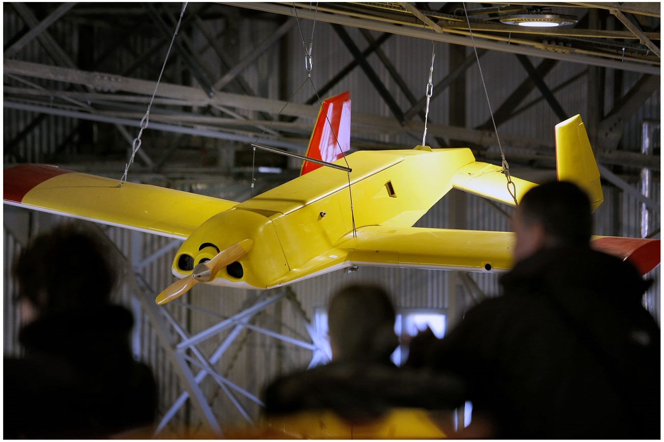 Yellow aircraft suspended from the ceiling of a hangar at the National Museum of Flight.