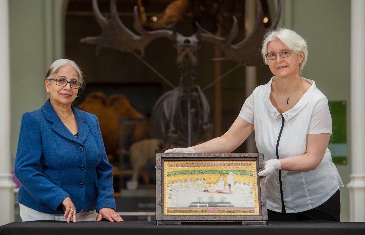 Friederike Voigt and Naina Minhas with a painting from the Archibald Swinton Collection June 2021