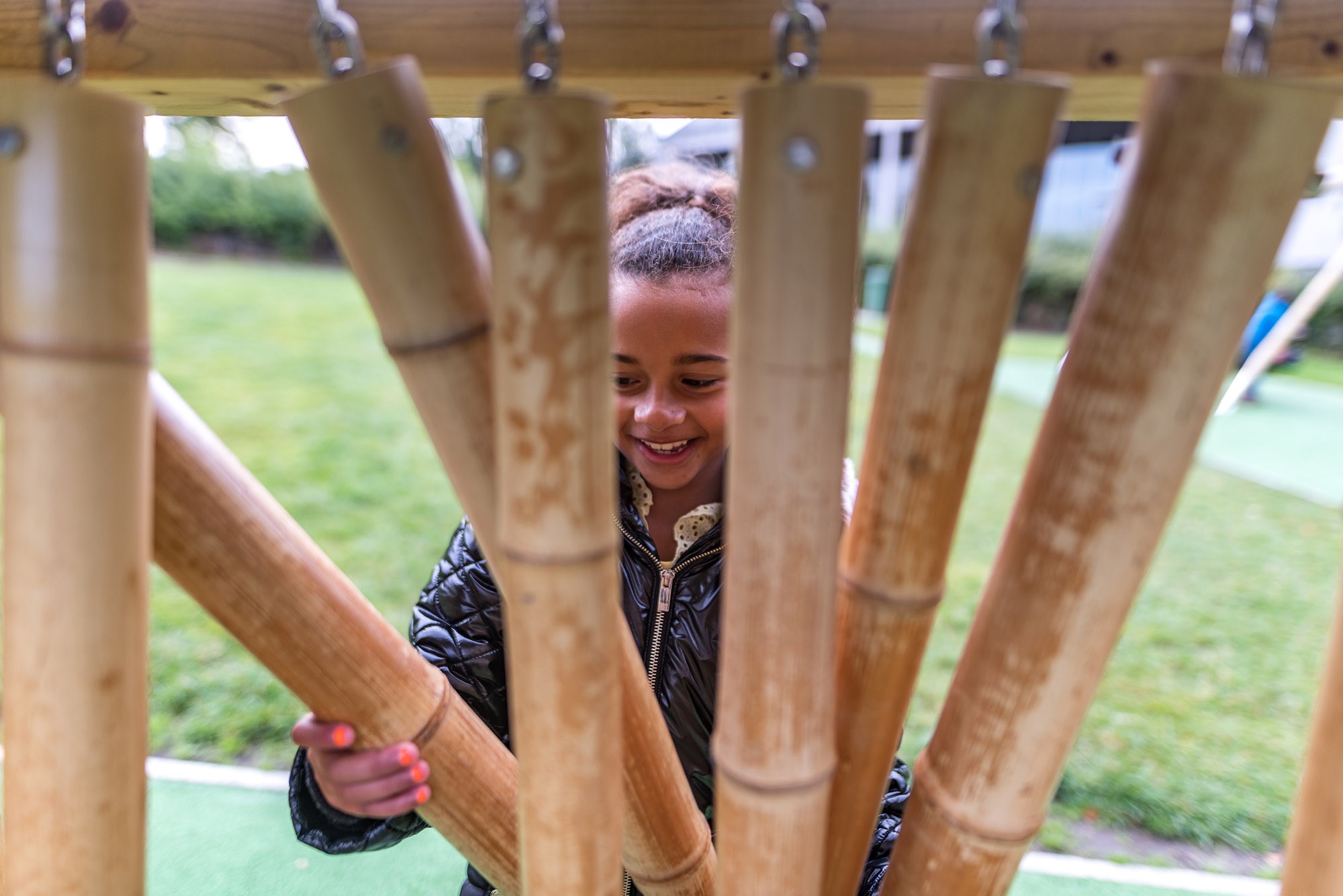 A child plays with bamboo chimes