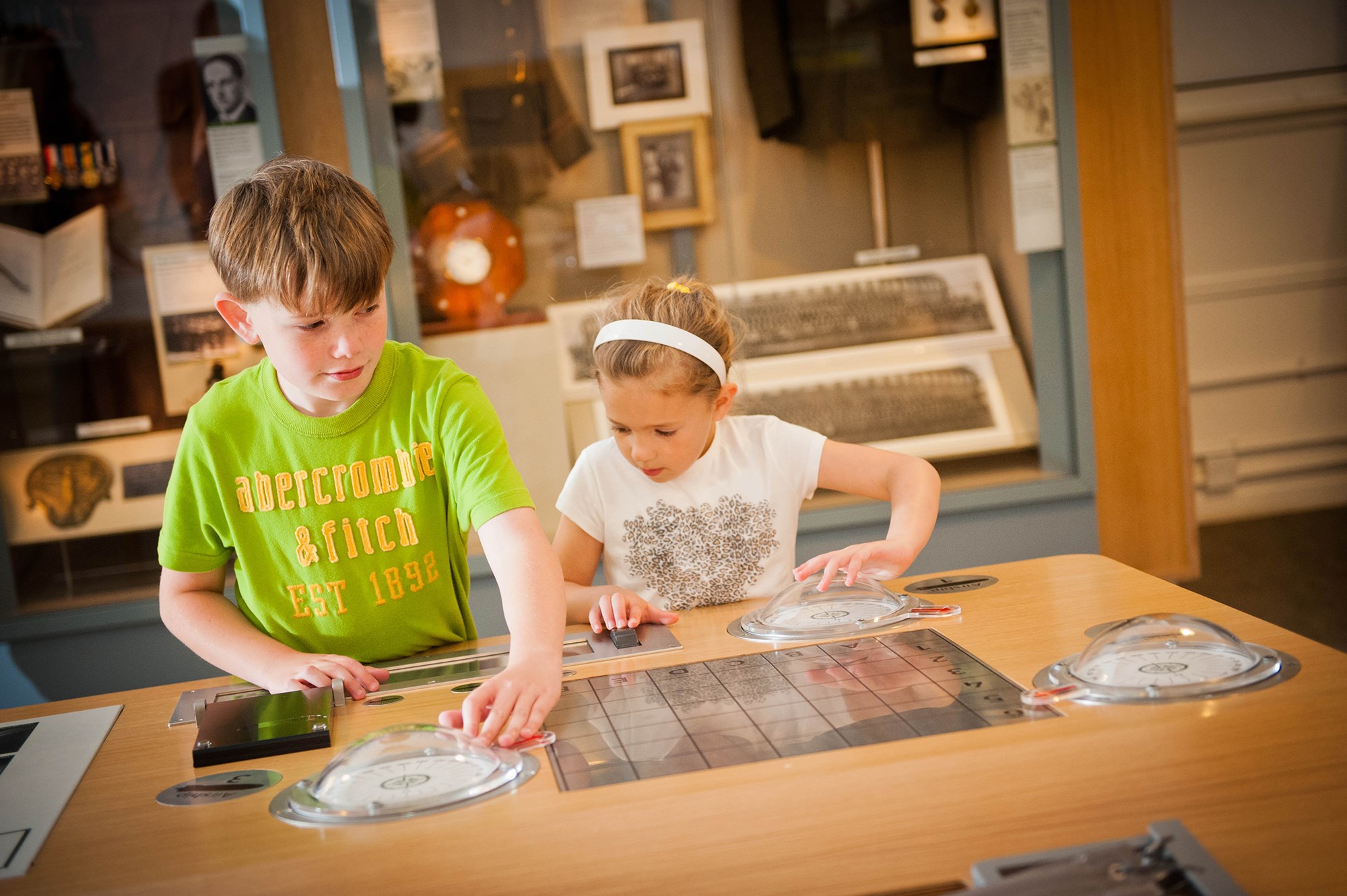 Two children interacting with a navigation display at the National Museum of Flight