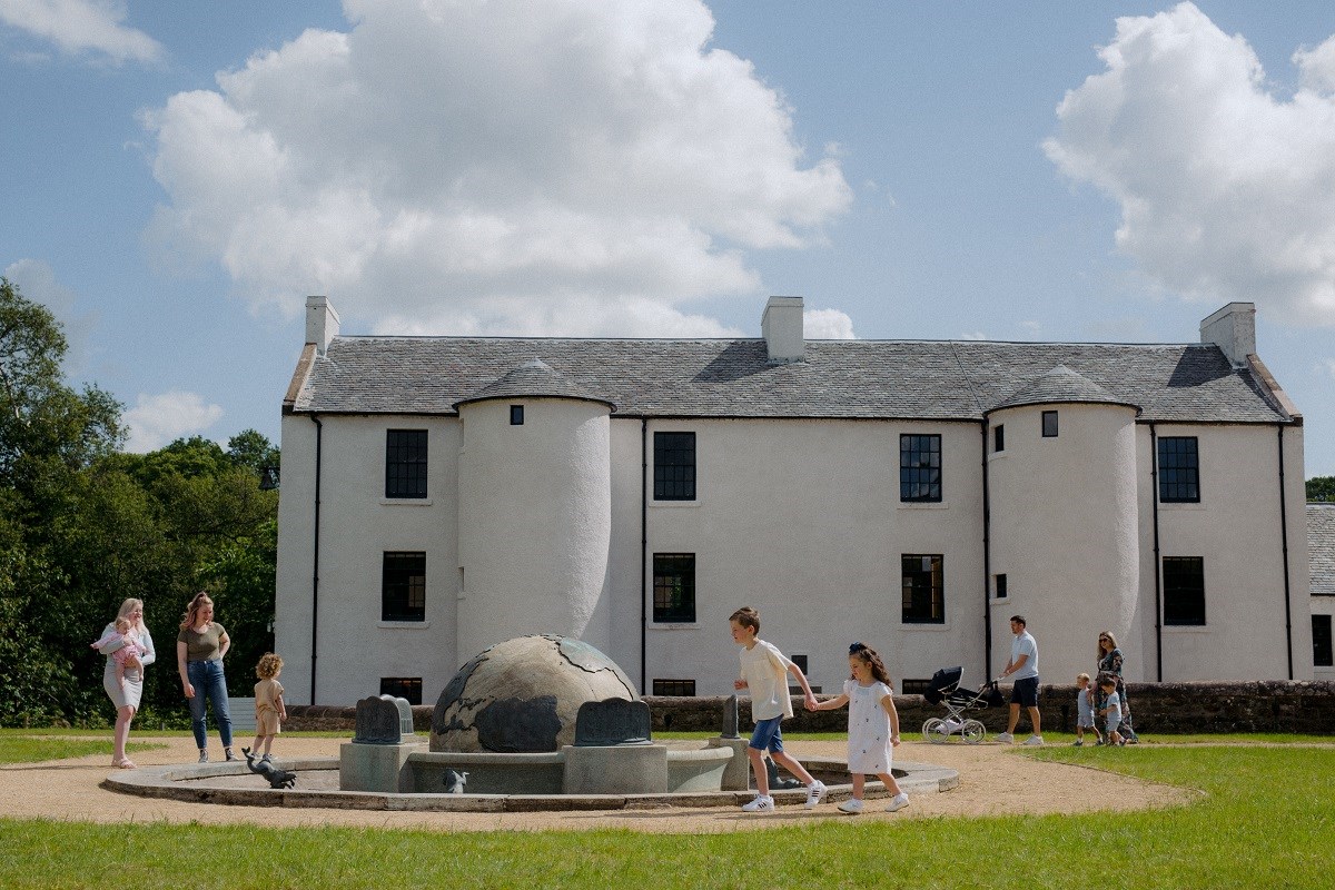 Exterior of David Livingstone Birthplace with families walking around