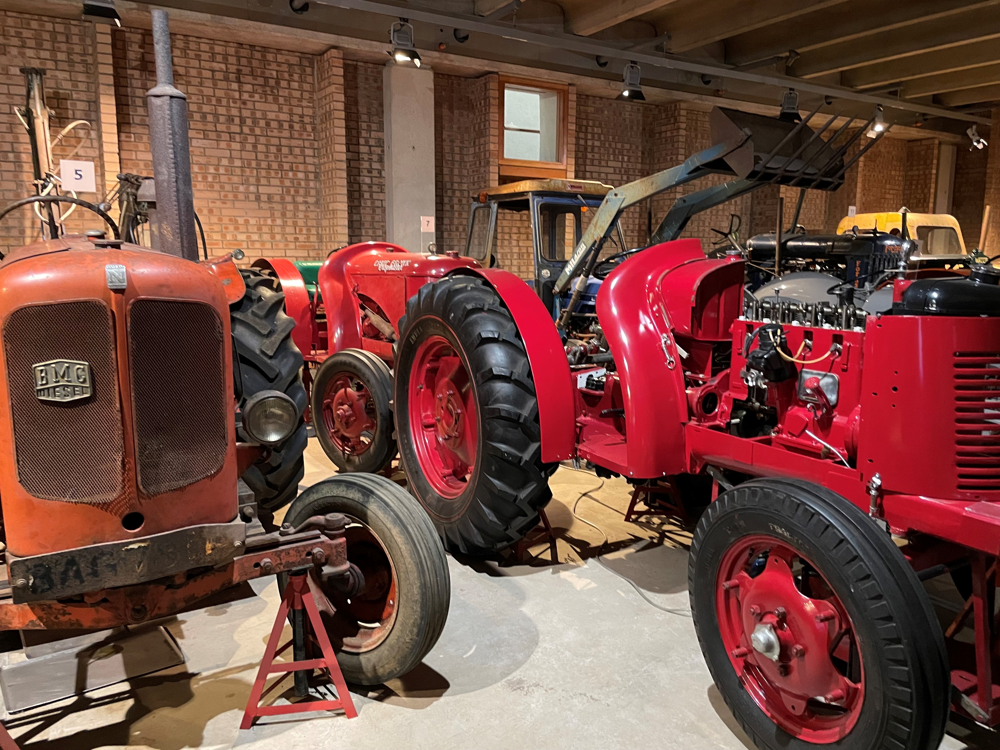 Two red tractors in a store at the National Museum of Rural Life. 