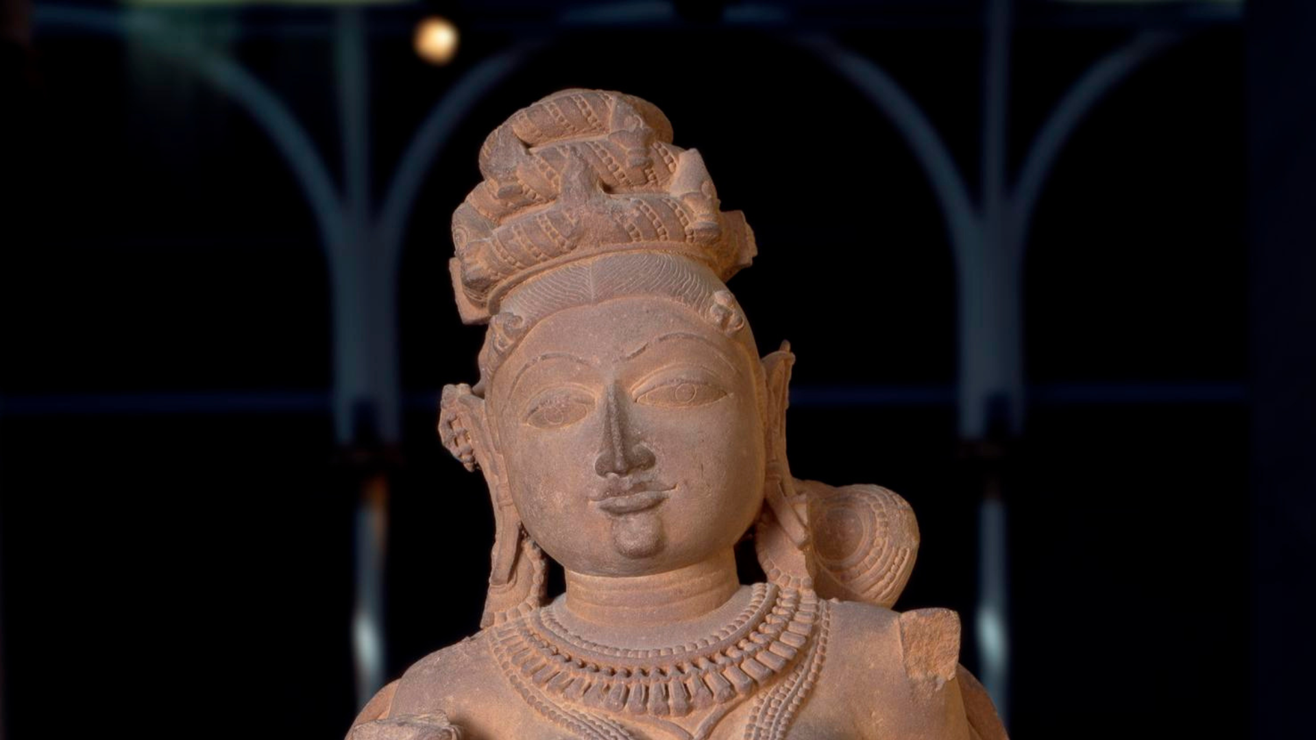 Figure of a Surasundari or divine beauty, wearing elaborate jewellery and with dressed hair, carved sandstone.