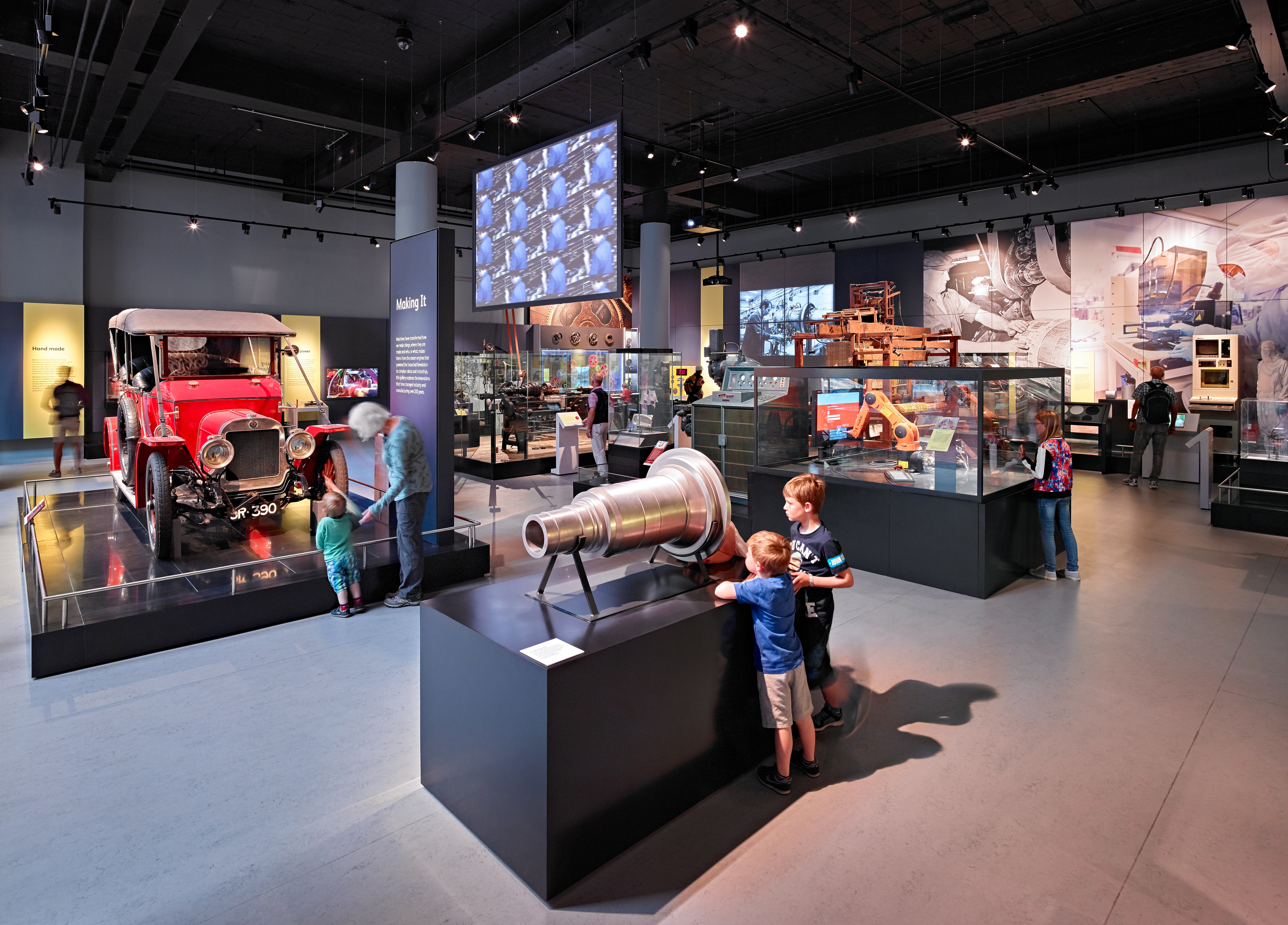 A number of visitors play with interactives and enjoy objects across the Making It gallery.