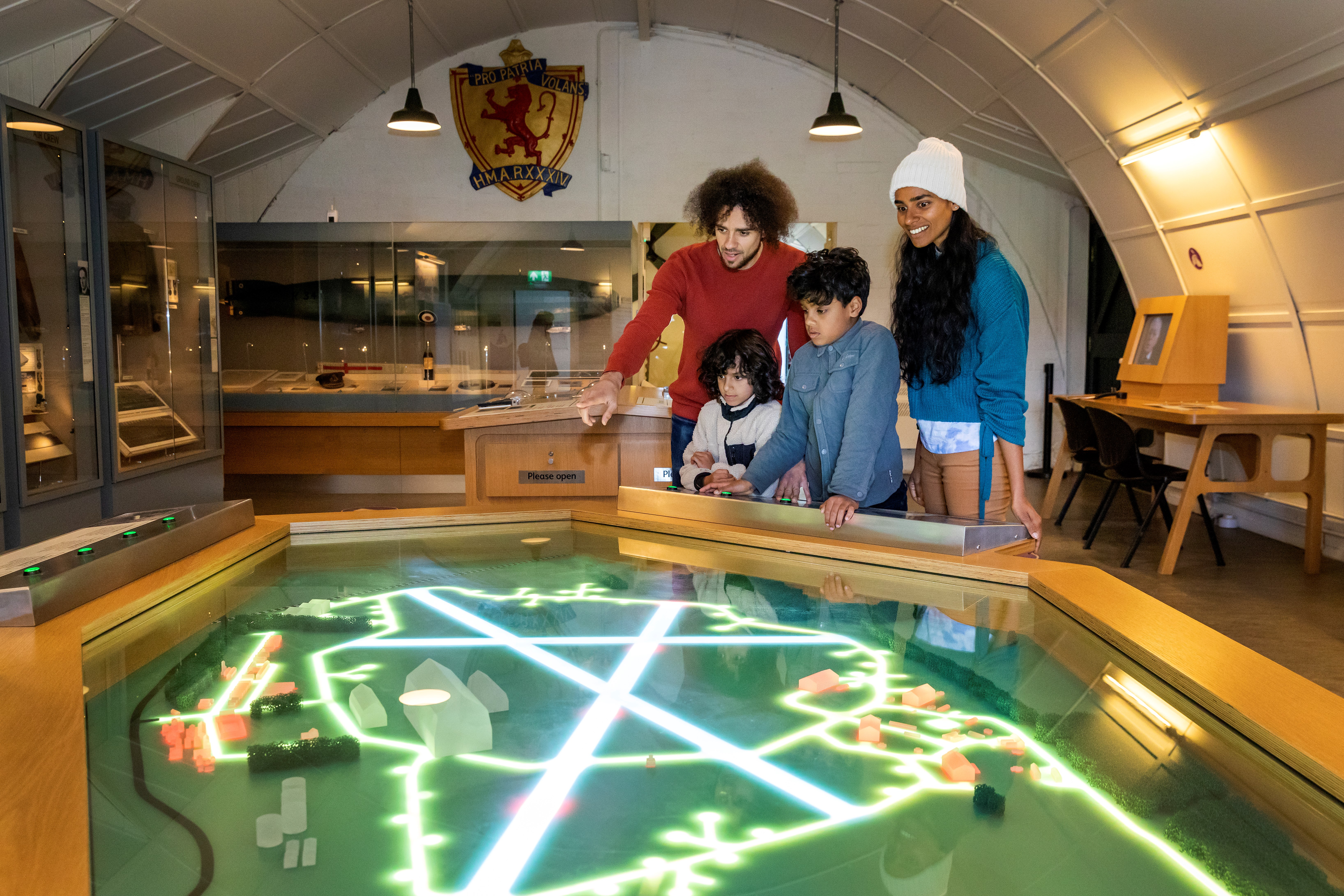 A family of four looking at an interactive display