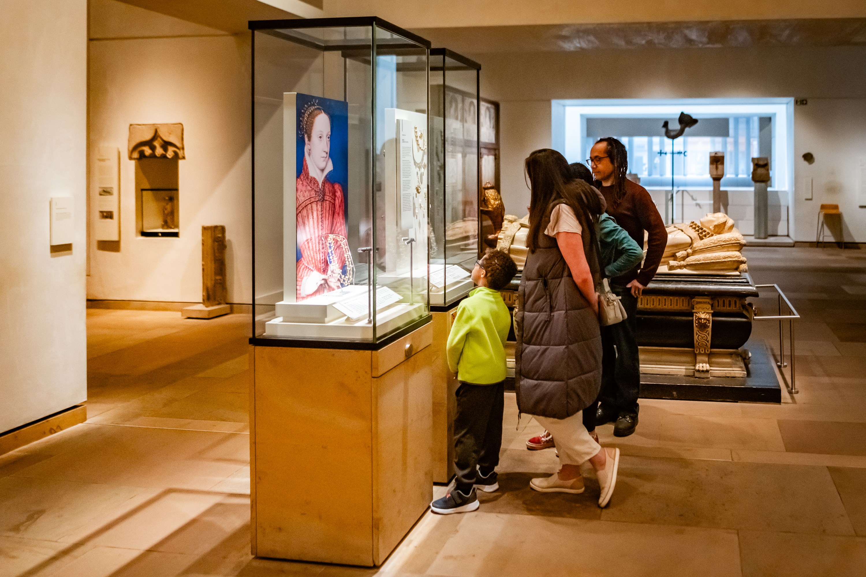 A group of visitors looking at jewellery in a case display