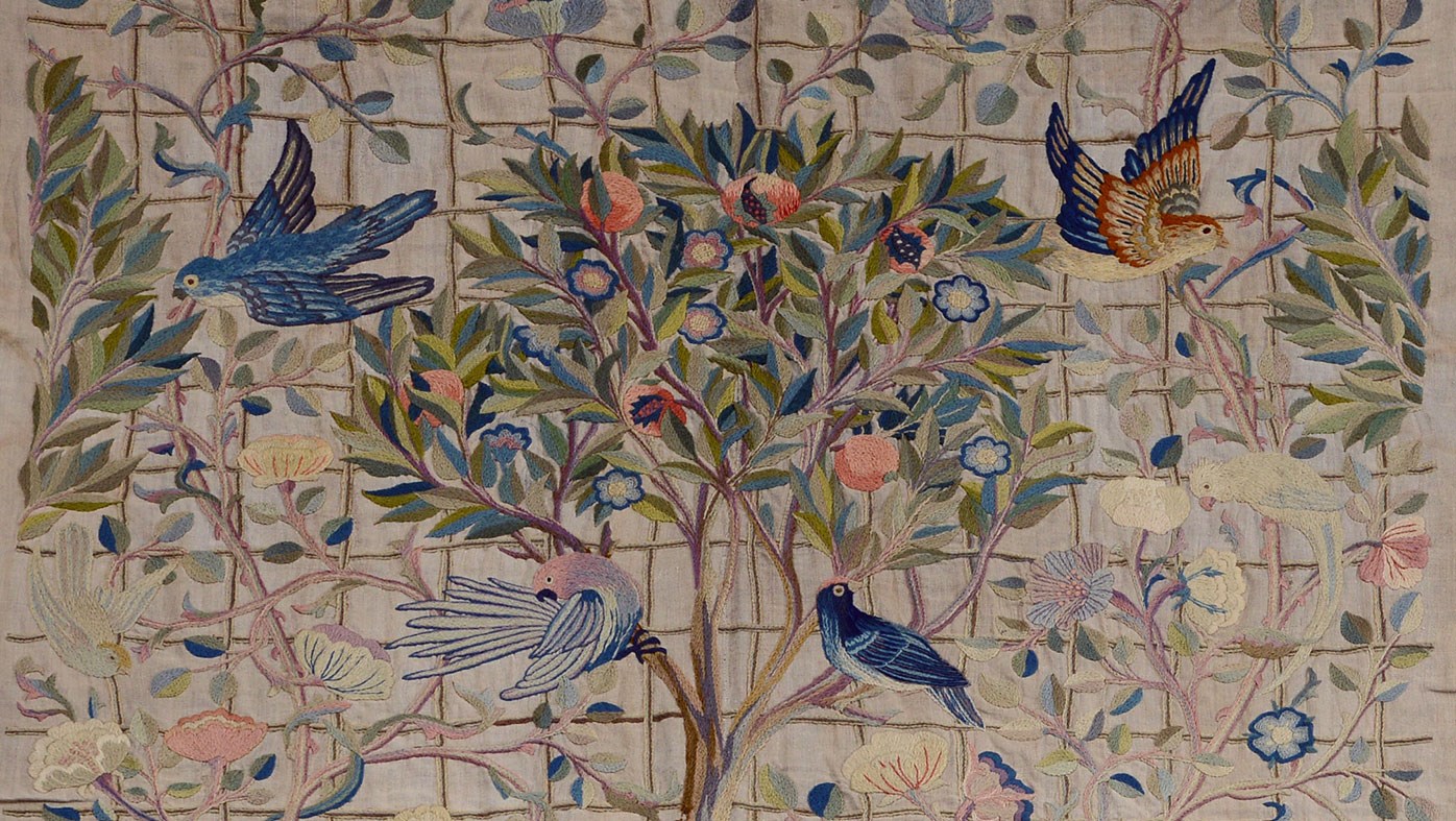 Embroidery of a group of colourful birds perching on a tree and branches.