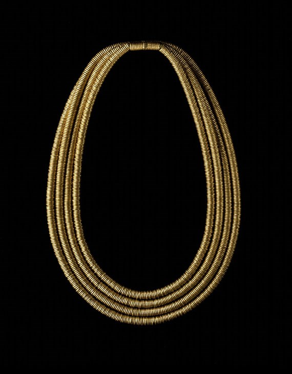 Gold Shebyu collar: consisting of four rows of gold rings threaded on a pad of fibre.