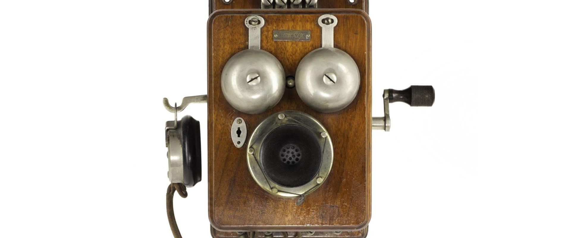 Wooden wall-mounted telephone with two bells, a crank, and an earpiece hanging from the side.
