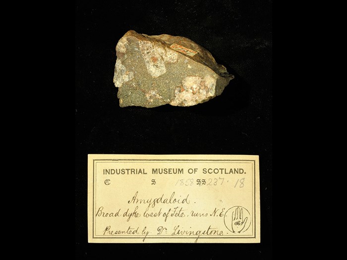 Specimen of amygdale with 19th century museum label: ‘Amygdaloid. Broad dyke west of Tete, runs NE. Presented by Dr Livingstone.’