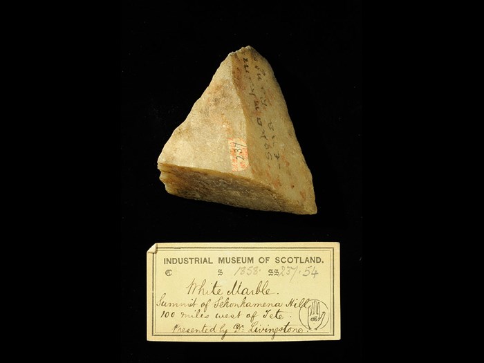 Specimen of white marble with 19th century museum label: ‘White marble. Summit of Sekankamena hill 100 miles west of Tete. Presented by Dr Livingstone.’