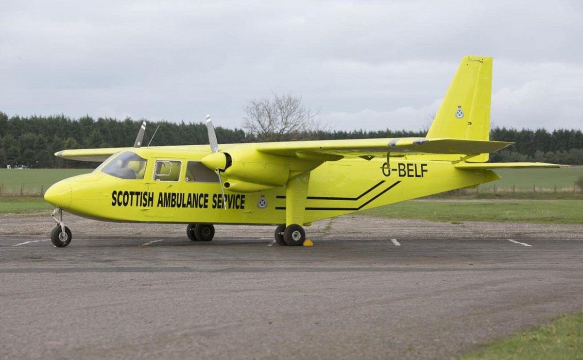 A bright yellow airplane that says 'Scottish Ambulance Service' on the side