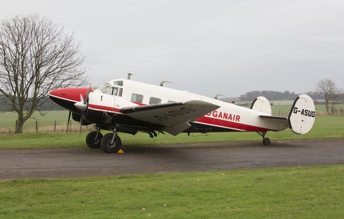 Side view of the Beech E-18S aircraft in an airfield at the National Museum of Flight.