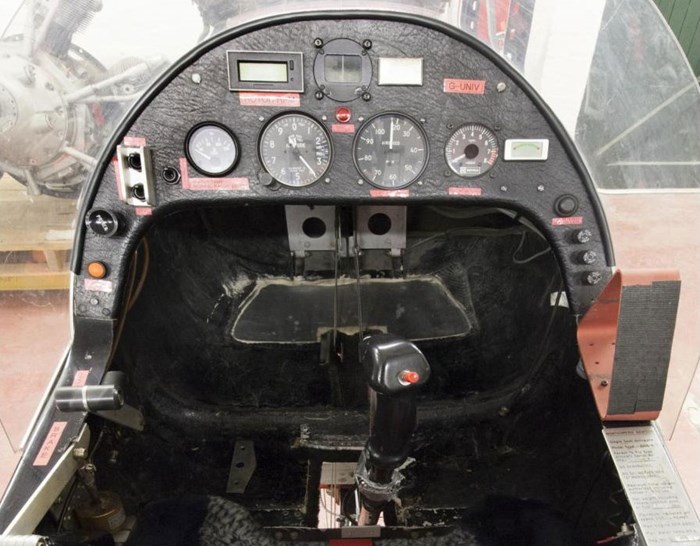 Inside the cockpit of a Montgomerie-Parsons autogyro. There are several dials and buttons on the dashboard.