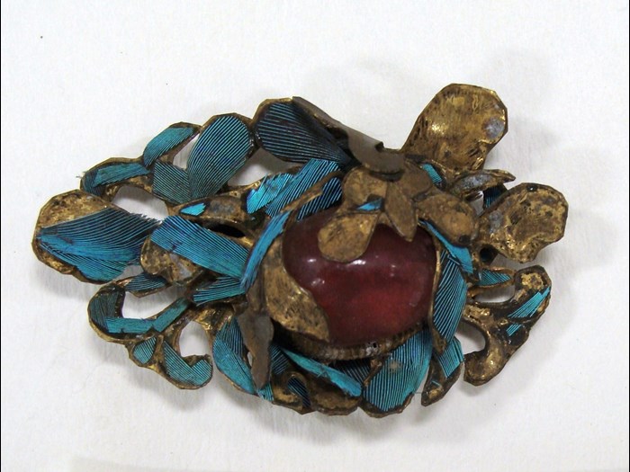 A jewel on the headdress before conservation
