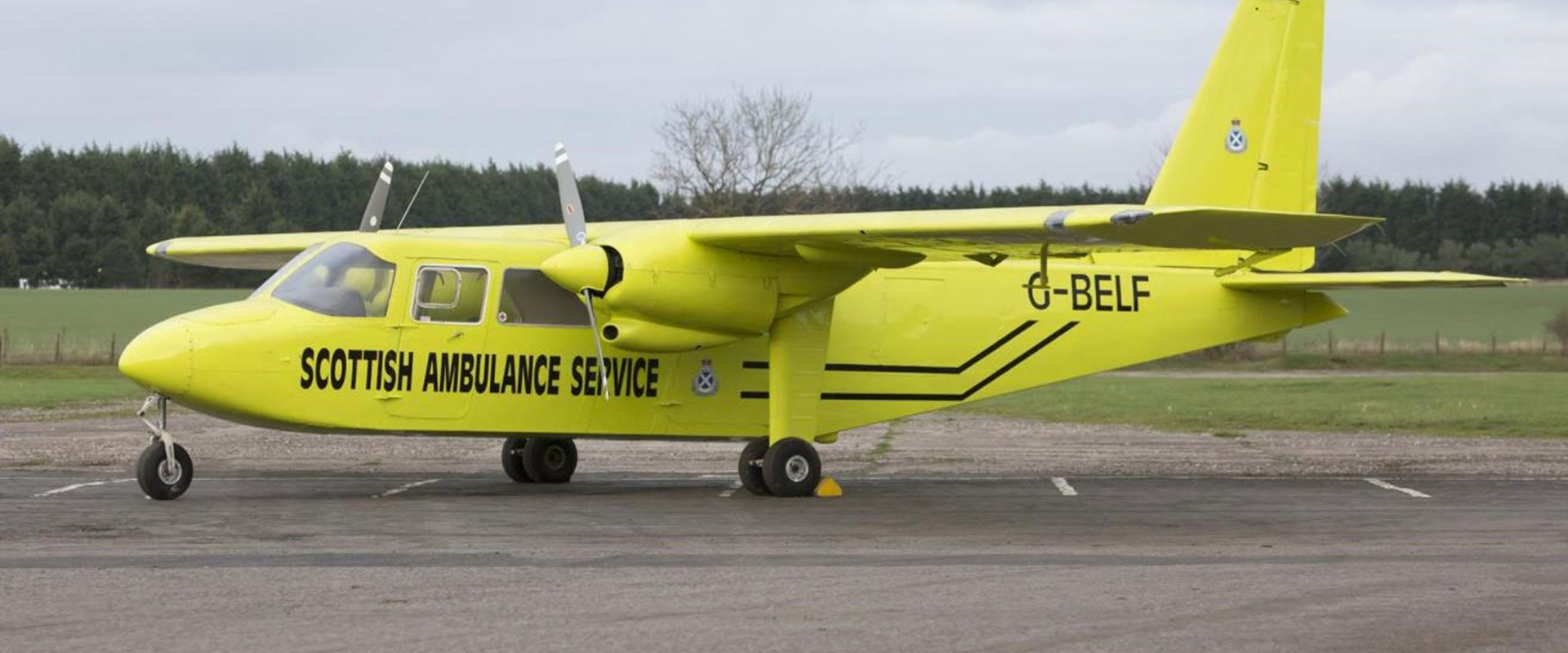 Bright yellow airplane that says 'Scottish Ambulance Service' on the side