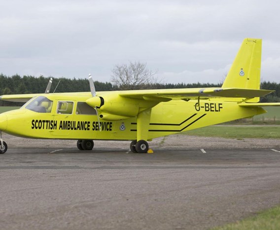 Bright yellow airplane that says 'Scottish Ambulance Service' on the side