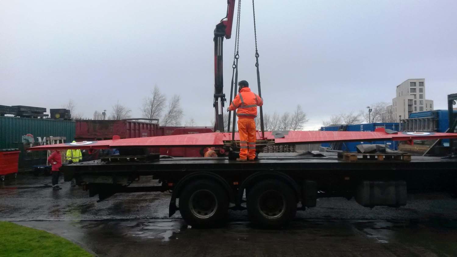 Hoisting the Hawk wings off a heavy loader lorry at National Museums Collection Centre.