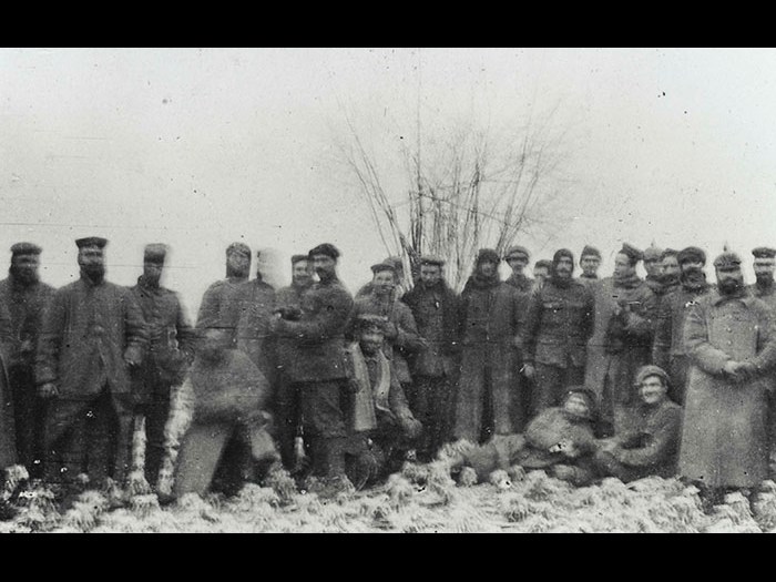 British and German soldiers pose together for the camera of Lieutenant AHC Swinton, 2nd Battalion Scots Guards, during the unofficial truce which occurred on parts of the front line on Christmas Day, 1914.