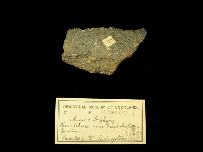 Specimen of augite porphyry with 19th century museum label: ‘Augitic Porphyry. River Lekone, near Great Falls, Zambesi. Presented by Dr Livingstone.’
