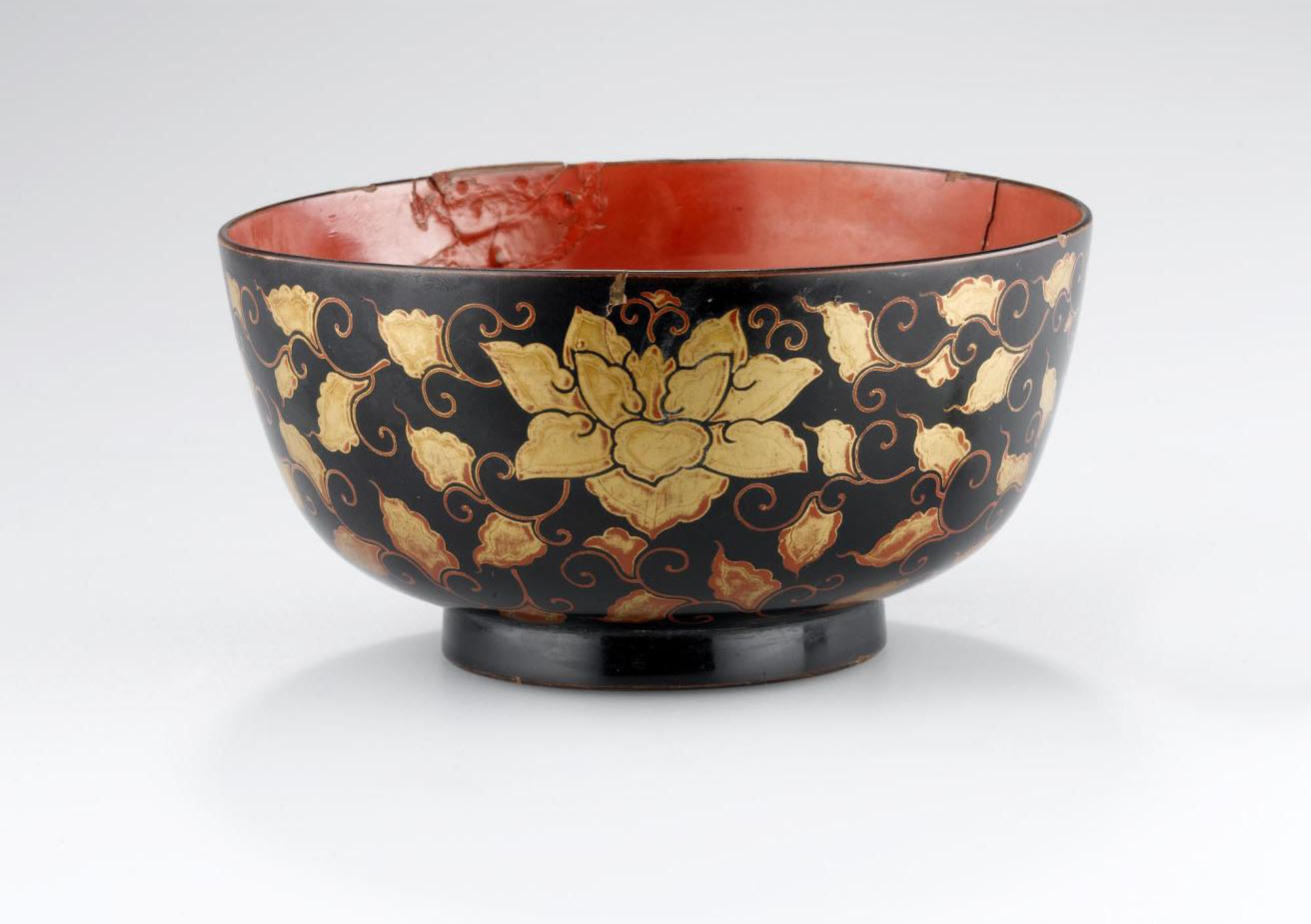 19th century cup made from wood decorated with black and red lacquer. Cup and stand sets (tuki) of Japanese lacquer were used by the Ainu in ceremonies. On display in the Living Lands gallery, National Museum of Scotland.