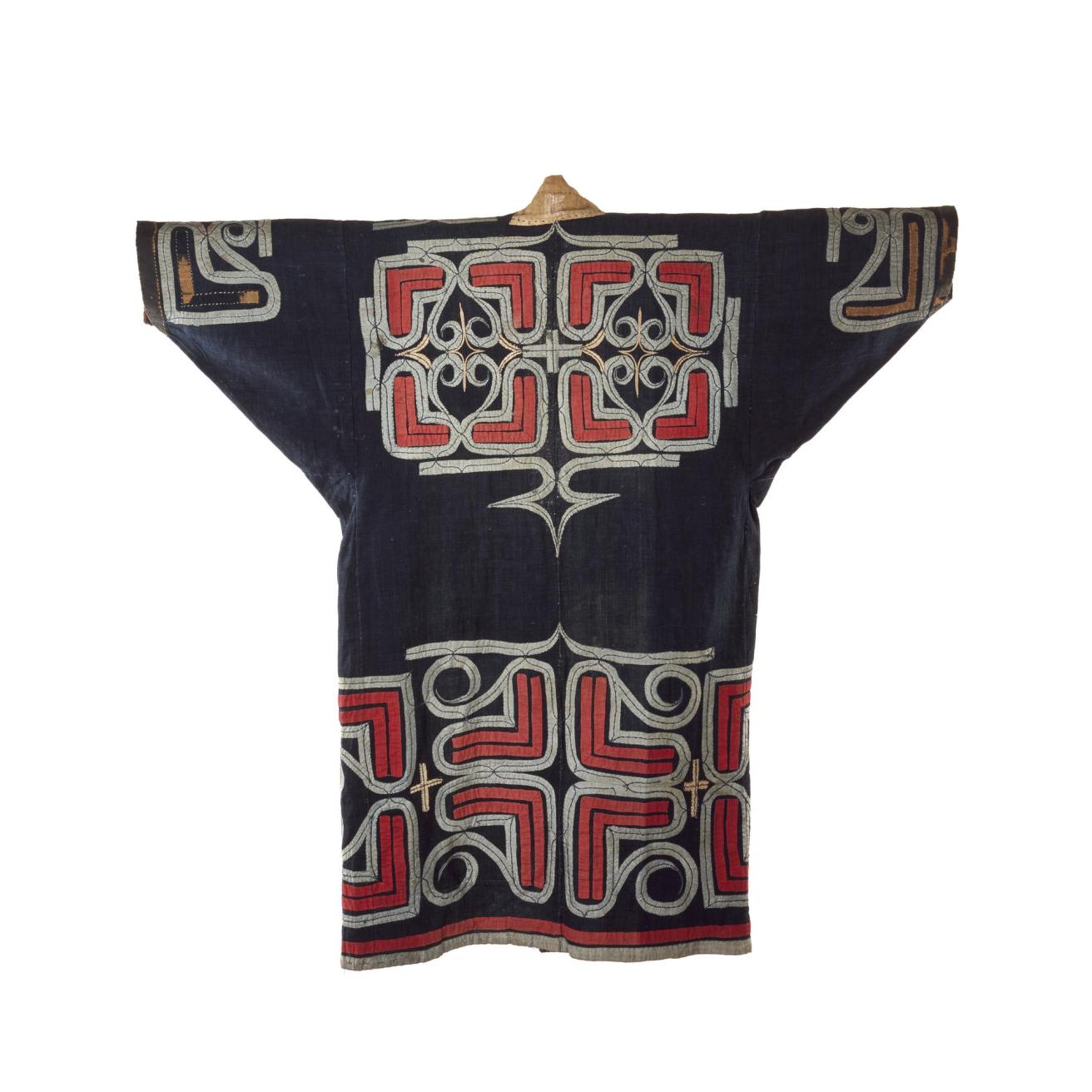 Robe (ruunpe), dark blue cotton cloth with red and white abstract applique decoration, worn during a ceremony: Japan, Hokkaido, Ainu, 19th to early 20th century. On display in the Living Lands gallery, National Museum of Scotland.