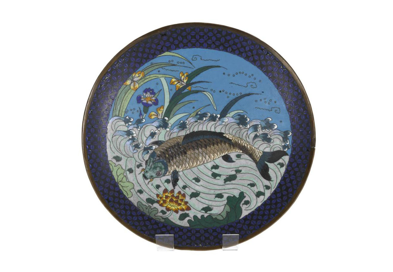 Dish of cloisonne enamel depicting a carp amongst waves with lotus and iris flowers. Japan, 19th century. On display in the Inspired by Nature gallery, National Museum of Scotland.