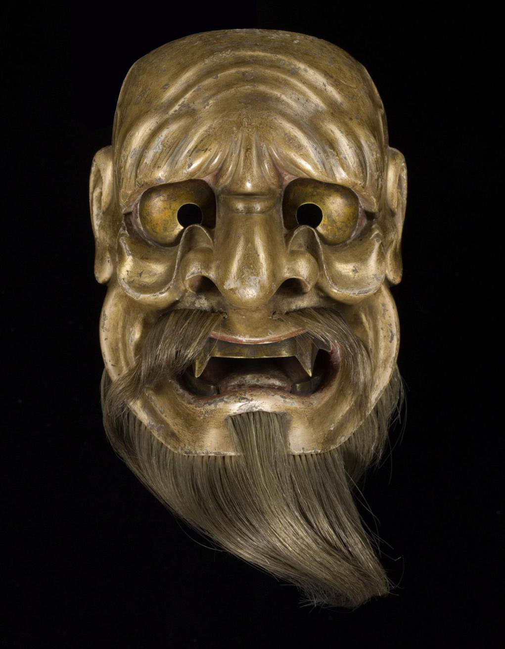 Mask representing the evil spirit Kaname-ishi, for No drama, signed: Japan, by Deme Tōhaku Mitsutaka, 1675-1715. On display in the Performance and Lives gallery, National Museum of Scotland.