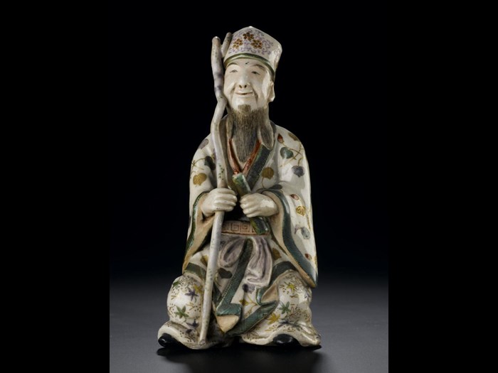 Figure of Jurojin seated on a small rock, from a set representing the Seven Gods of Good Fortune: Japan, Satsuma, 19th century. On display in the Window on the World, National Museum of Scotland. 