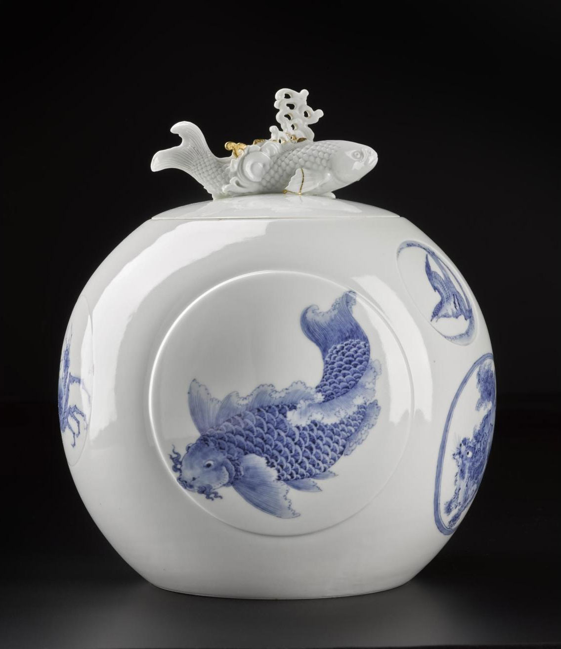 Spherical water jar of porcelain with underglaze blue decoration of carp, lion-dogs and children: Japan, Hirado Mikawachi, 1780 - 1880