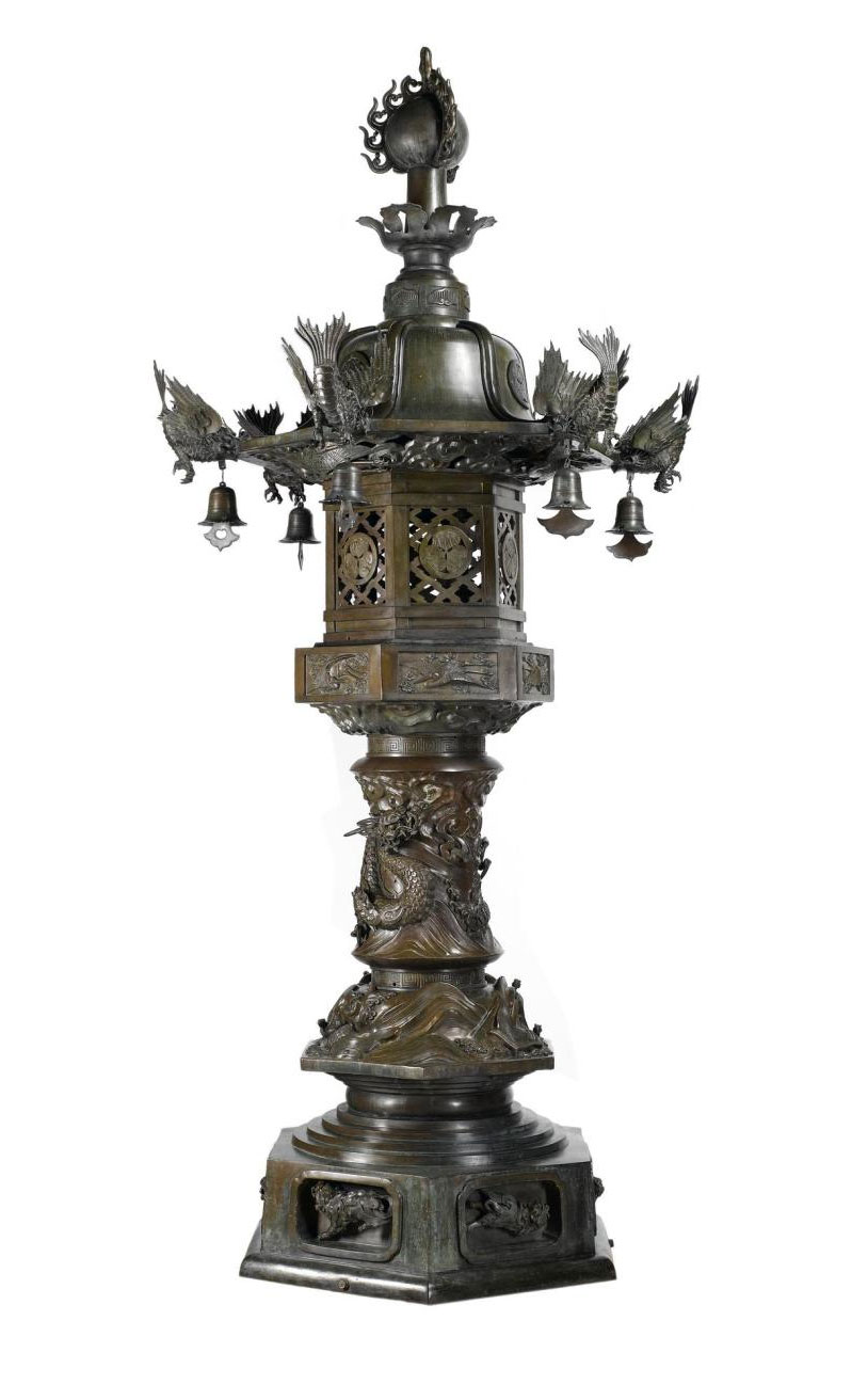 Temple lantern of bronze decorated with lion-dogs, dragon, cranes, mythological fish (shachihoko) and the crest of the Tokugawa family, and topped with a Buddhist flaming jewel: Japan, late 19th century.