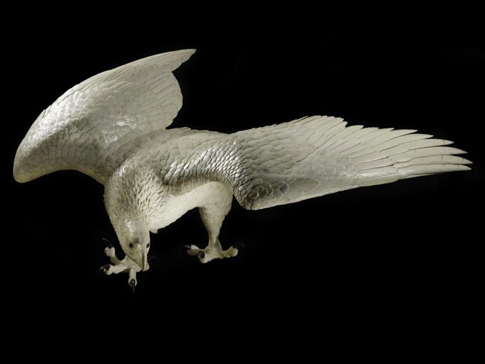  Figure of an eagle in carved ivory, perched with outstretched wings, with horn claws and glass eyes: by Kaneda Kenjiro, Japan, late 19th century .