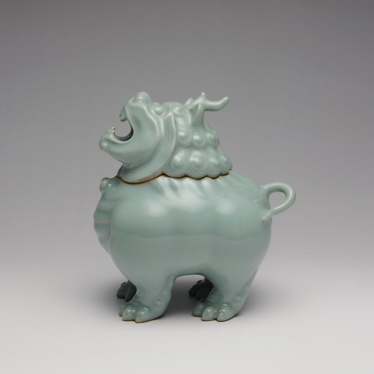 Incense burner of stoneware with celadon glaze in the form of a lion-dog, in two parts: Japan, by Suwa Sozan II, 1922-77.