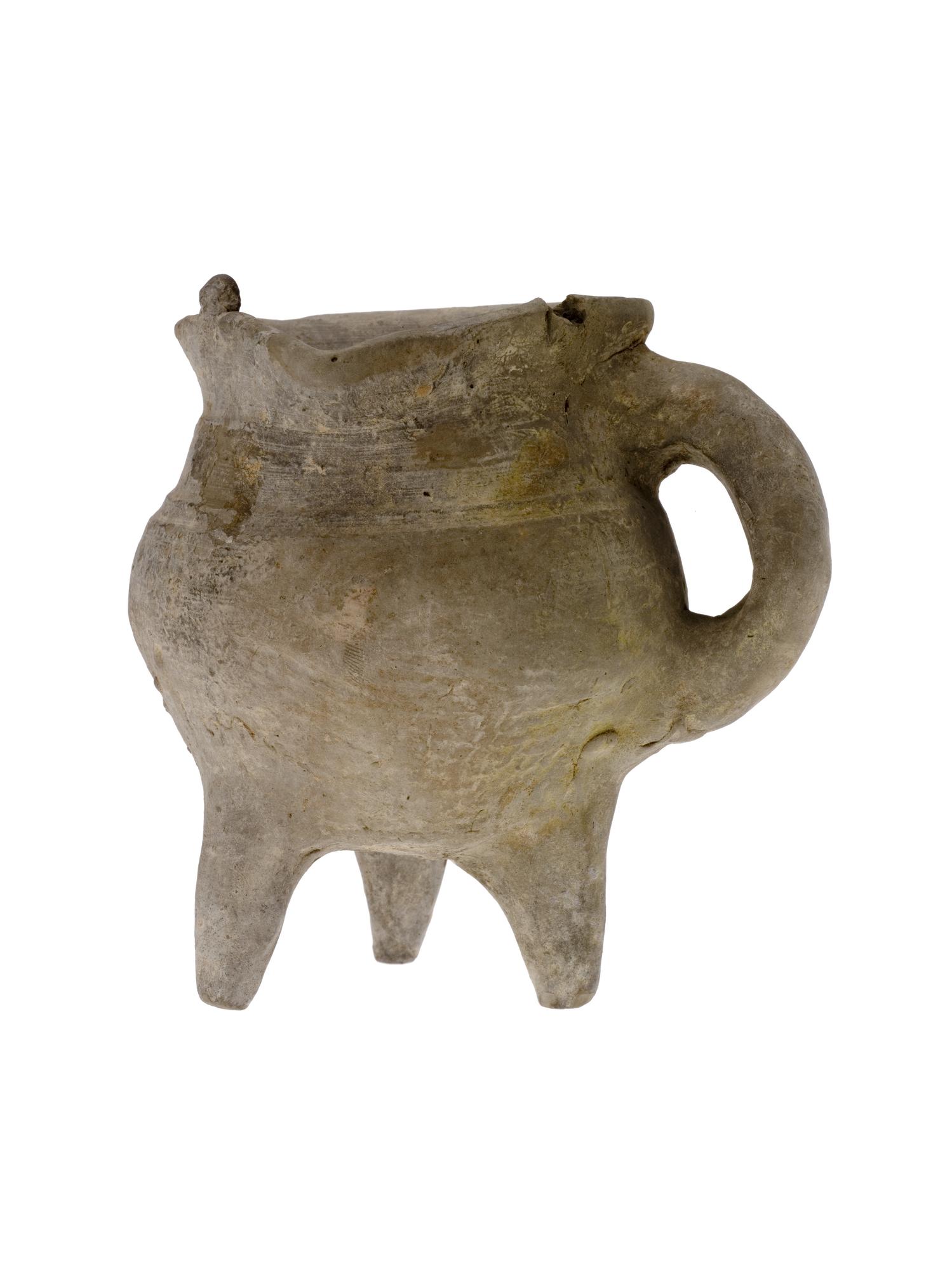 Jue (vessel) of rough grey unglazed earthenware, with a bulbous body standing on three short tapering legs, and mat impressions: China, Shang dynasty, c.1500-1050 BC.