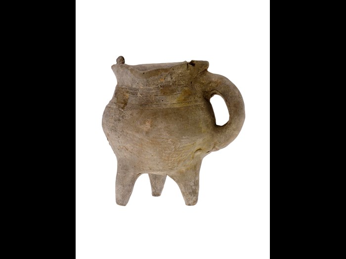 Jue (vessel) of rough grey unglazed earthenware, with a bulbous body standing on three short tapering legs, and mat impressions: China, Shang dynasty, c.1500-1050 BC.