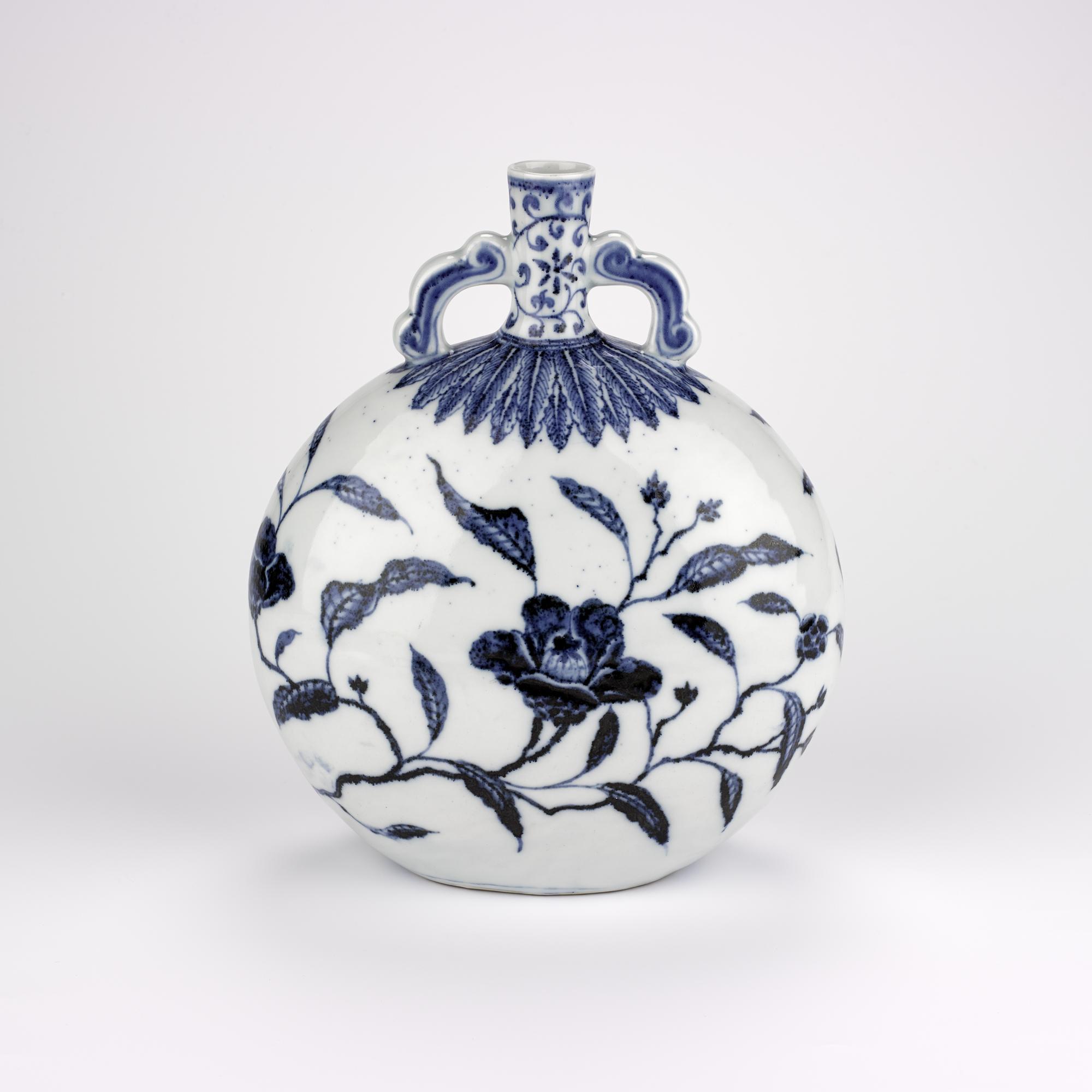 Porcelain moon vase, moon-shaped with narrow neck and two scrolled handles, painted in underglaze cobalt blue with magnolia flowers and leaves: China, Jiangxi Province, Jingdezhen kilns, Ming Dynasty, early 15th century AD.