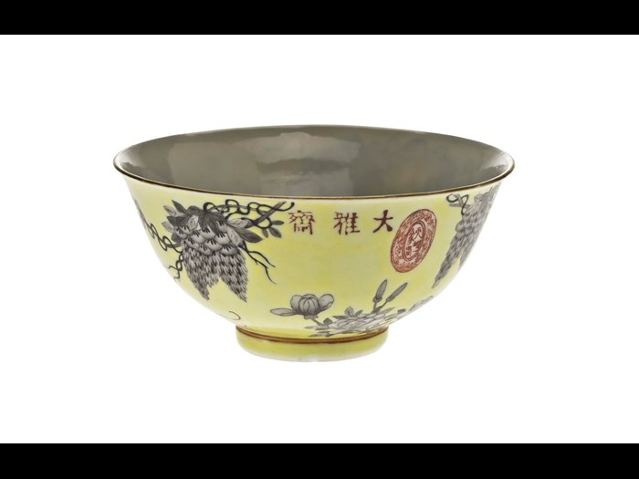 Porcelain bowl decorated in overglaze enamels with a yellow ground and grisaille design of wisteria, peony and a bird, with inscription and marks, part of a porcelain group made in celebration of the 60th birthday of the Empress Dowager Cixi: China, Jiangxi Province, Jingdezhen kilns, Qing Dynasty, Guangxu reign, 1894 AD.