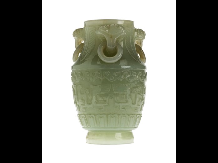 Vase of mutton-fat jade with three loose ring handles, carved with symmetrical designs of archaic dragons: China, 18th century.